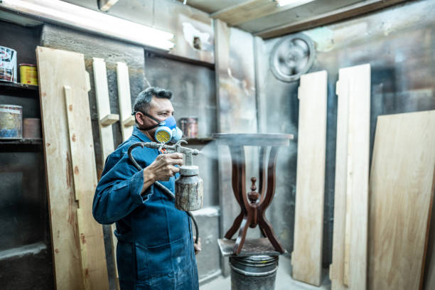 istock Mature painter painting old furniture at carpentry workshop 1480951448