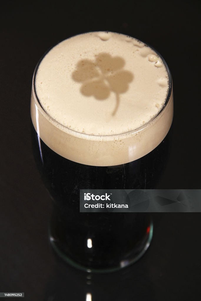 St. Patrick's day A pint of irish stout for St. patrick day, with a clover imprinted in the head of the beer. Alcohol - Drink Stock Photo