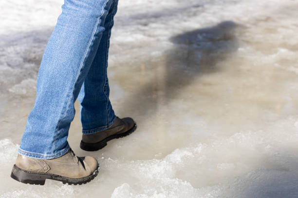 istock woman walking on ice in the park. 1480953450
