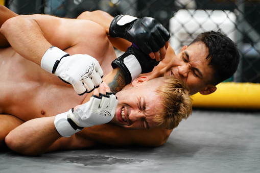 Mixed Martial Art, When the opponent is knocked down then use your hands to strangle your opponent's neck. making it difficult for the opponent to find a way to fight back