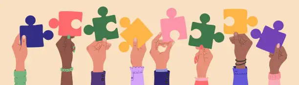 Vector illustration of Human hands of different ethnicity people holding a pieces of jigsaw. Team cooperation and communication.