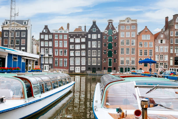 istock Amsterdam built along canal in central Amsterdam. Blue cloudy Sky on the background. 1480956123