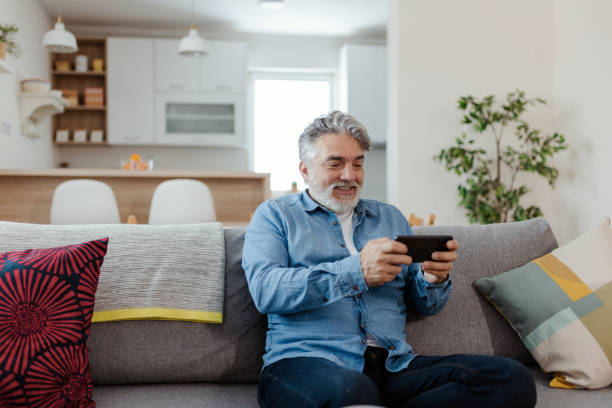 istock Playing Game by Mobile Phone at Home 1480956725