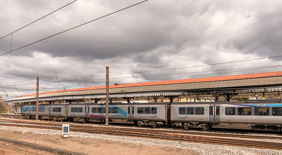 York, UK.  April 7, 2023.  A long line of carriages are parked beside a 19th century canopy. Electric cables are running overhead and a cloudy sky is above.