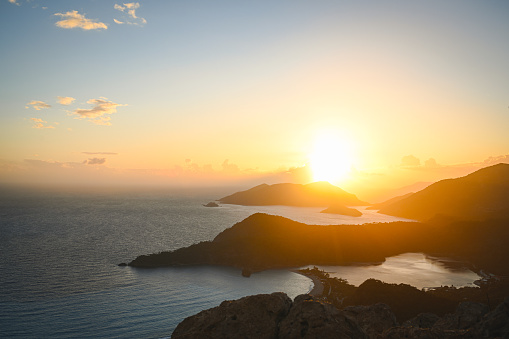 sunset over sea and mountain landscape