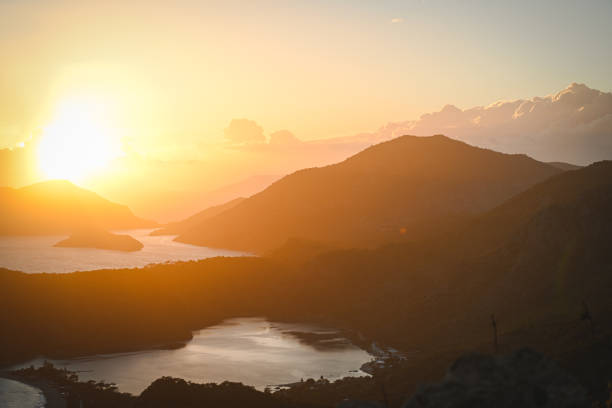 sunset over sea and mountain landscape
