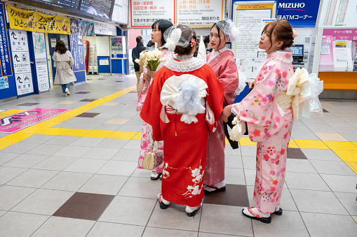 Tokyo, Japan - March 16, 2023: women dressed in traditional clothes dressed like geishas using the metro in Tokyo.