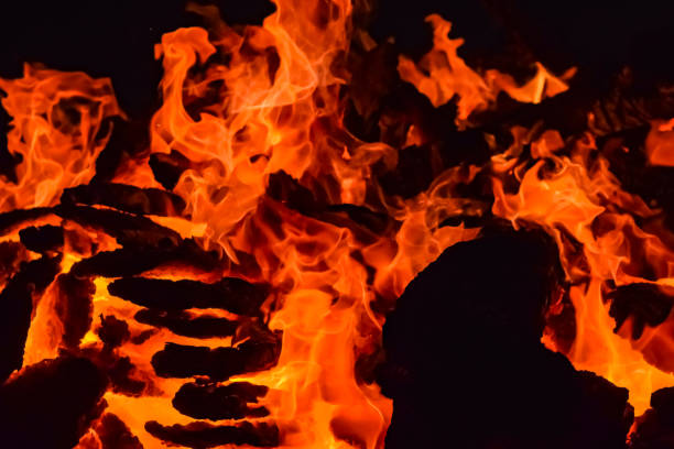 istock Fire flames on black background, Blaze fire flame texture background, Beautifully, the fire is burning, Fire flames with wood and cow dung bonfire 1480967918