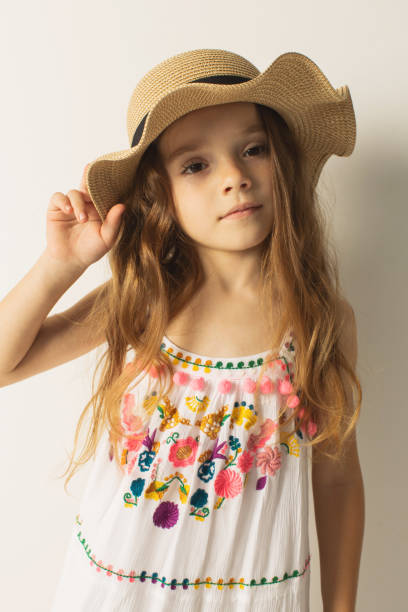 blonde girl in white dress and hat in studio on white background. style - hot couture imagens e fotografias de stock