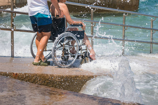 istock Man with disability on wheelchair at beach 1480969130