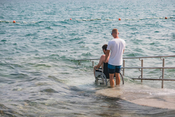 istock Man with disability at beach goes to swimm 1480969169