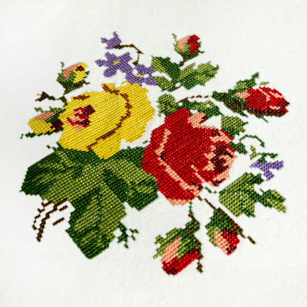 刺繍された花。クロスステッチハンドワーク。白い亜麻に赤、黄、パステルピンクのバラ。 - cross stich ストックフォトと画像