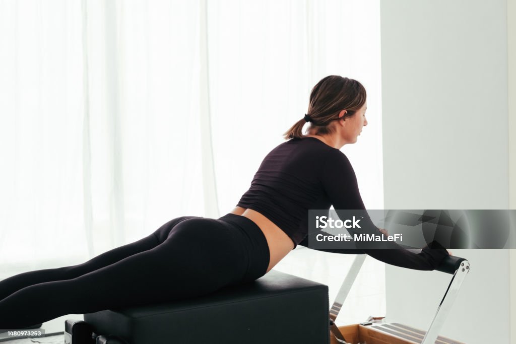 Woman Doing Pilates On Reformer Bed Pilates Reformer Girl Doing ...