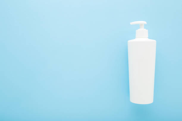 istock White big plastic pump bottle on light blue table background. Pastel color. Care about clean and soft body skin. Daily beauty product. Closeup. Empty place for text or logo. Top down view. 1480973303
