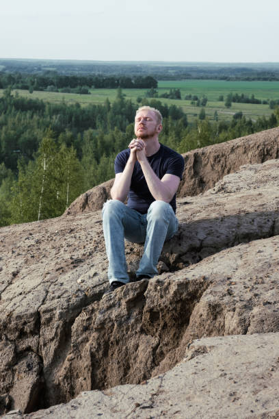 istock A man surrounded by mountains. Hope, faith and prayer 1480974791