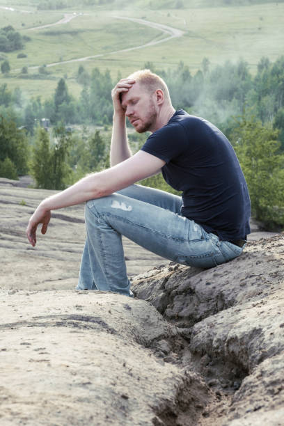 istock A man surrounded by mountains. Thoughtfulness and loneliness 1480974822