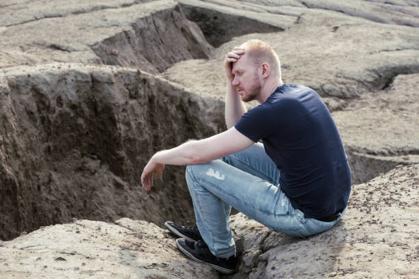 istock A man surrounded by mountains. Thoughtfulness and loneliness 1480974859