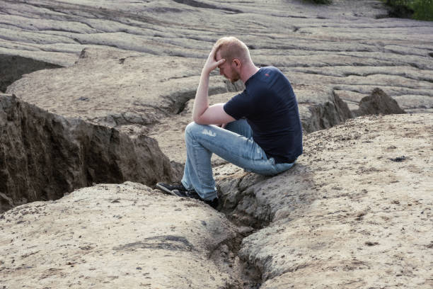 istock A man surrounded by mountains. Thoughtfulness and loneliness 1480974989