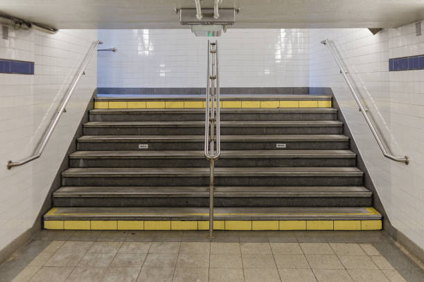 istock Subway stairs with hand rails, low ceilings and tiled walls 1480976089
