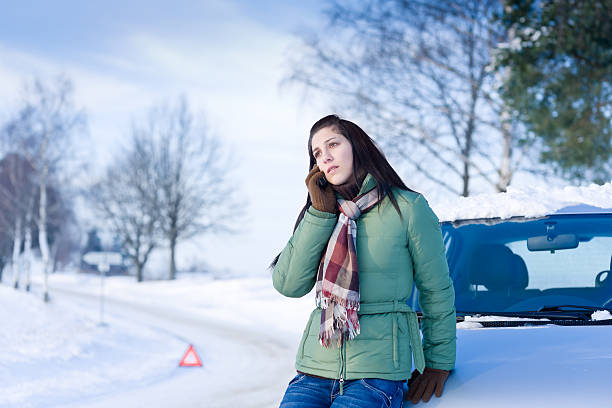 Winter car breakdown - woman call for help stock photo