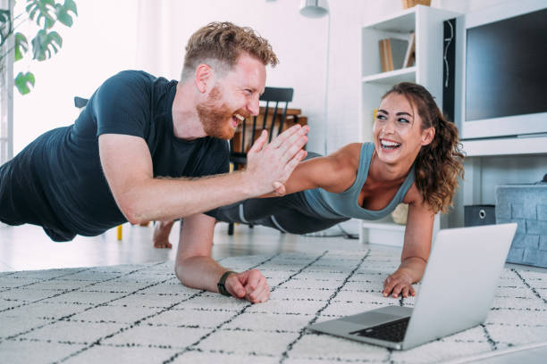 istock Couple exercising together at home. 1480979156
