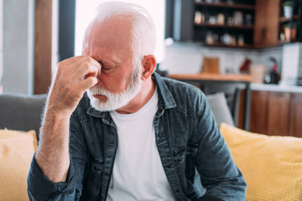 istock Senior man suffering with a migraine. 1480979175