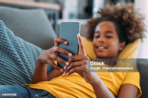 Girl Using Smartphone At Home Stock Photo - Download Image Now - Teenage Girls, Child, Mobile Phone