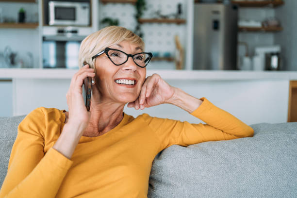 istock Woman talking on mobile phone at home. 1480979198