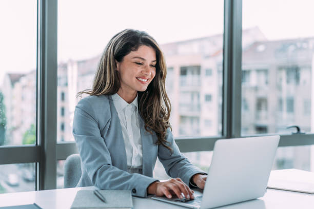 istock Successful businesswoman in modern office working on laptop. 1480979218