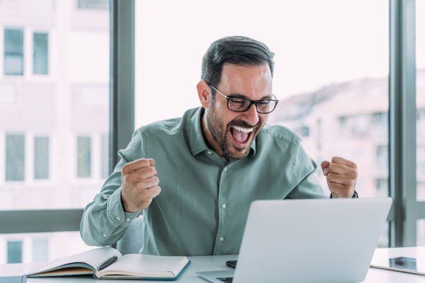 istock Handsome businessman celebrating his success. 1480979221