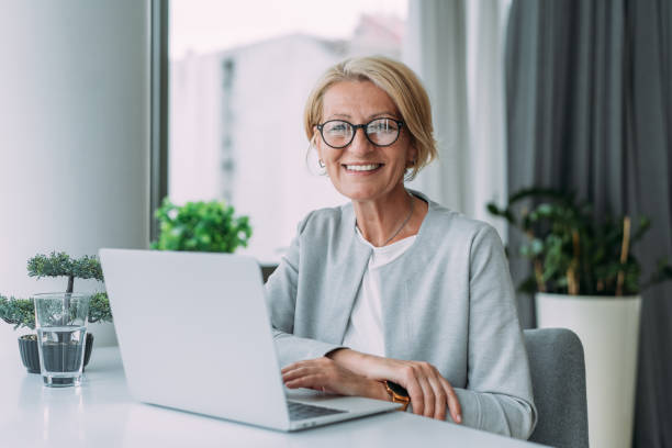 istock Successful businesswoman in modern office working on laptop. 1480979245