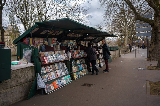 One of the Bouquinistes, selling antique books along the river Seine in Paris, France. March 24, 2023.