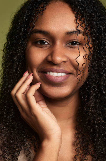 istock Smiling African American woman touching cheek 1480981807