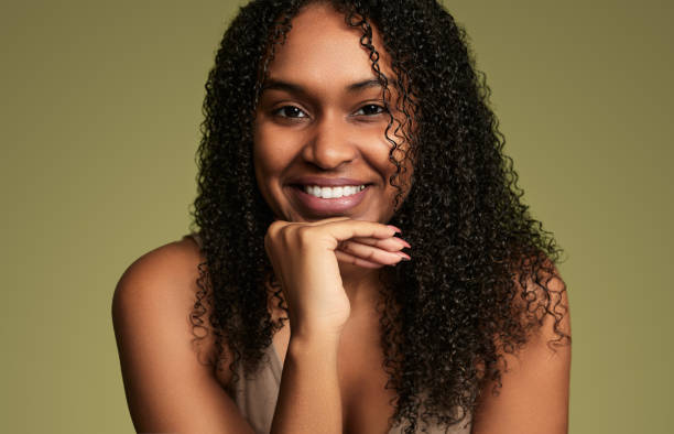 istock Smiling black woman with hand on chin 1480981827
