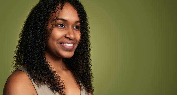 istock Smiling Hispanic woman looking away in studio 1480981866
