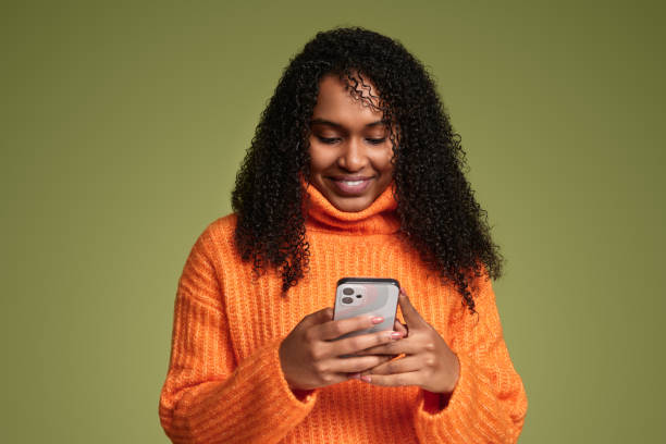 istock Cheerful ethnic woman using smartphone in studio 1480981896
