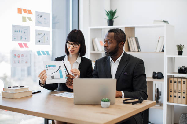 istock Managers conducting video call via laptop at office desk 1480983645