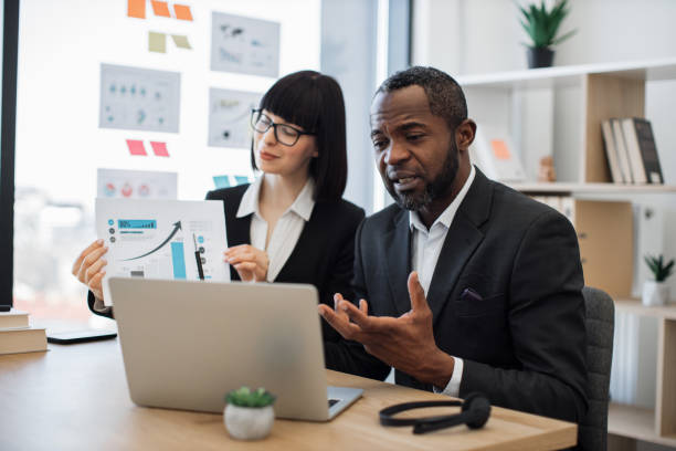 istock Business partners working online with graphs using laptop 1480983658