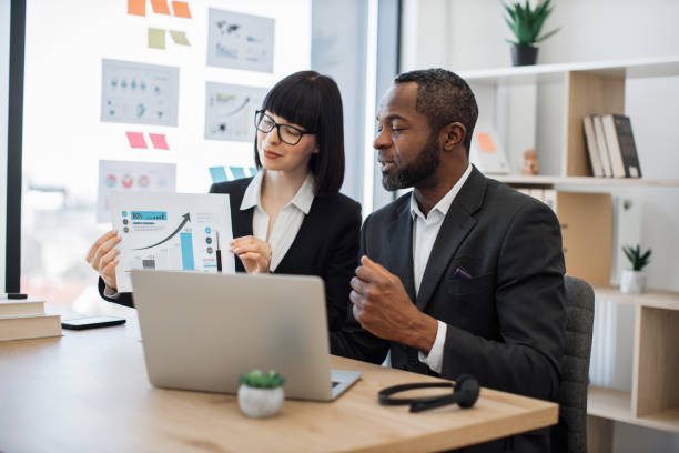 istock Business partners working online with graphs using laptop 1480983660