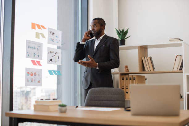 istock Employer having conversation on cell phone in workplace 1480983696