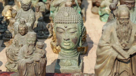 Buddha statues and other miscellaneous items are sold together in the flea market