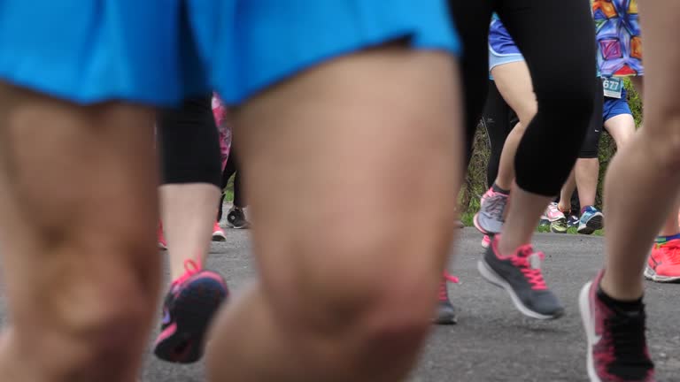 Charity marathon running basically females people crowd legs in sneakers slow motion