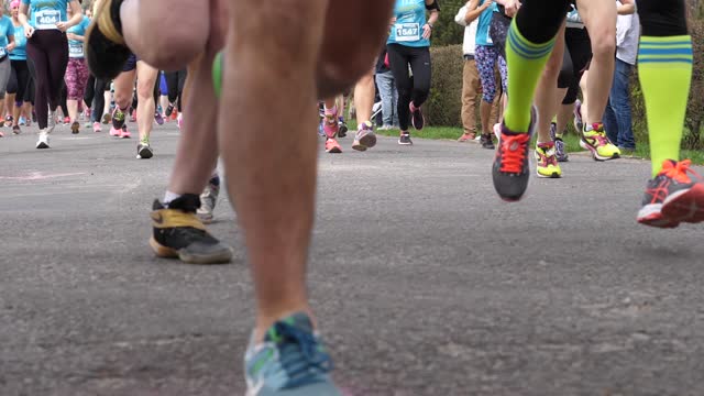 Charity marathon running basically females people crowd legs in sneakers slow motion
