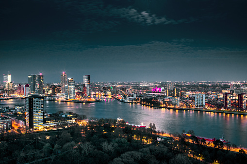 Dutch cityscape view of night time Rotterdam from above