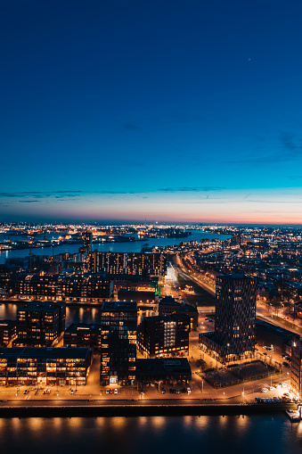 Dutch cityscape view of night time Rotterdam from above