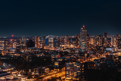 Dutch cityscape view of night time Rotterdam from above