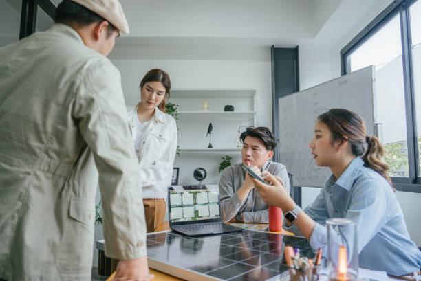 istock Asian businessman raising a question while in a meeting about the new solar panel model. 1480989479