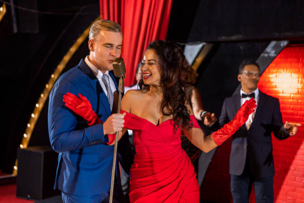 istock Beautiful couple of performers singing on stage 1480990848