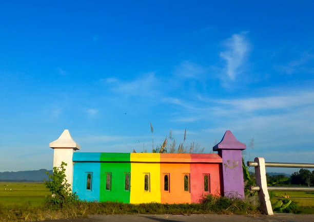 istock Architectural feature, outdoor rainbow concrete wall with blue sky background 1480991101