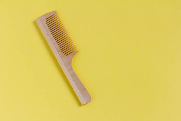 istock Wooden comb on a yellow background, top view. 1480991492